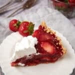 A slice of strawberry pie on a white plate.