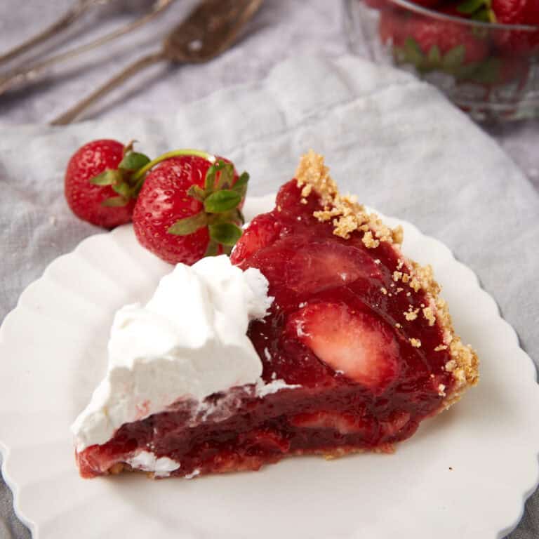 A slice of strawberry pie on a white plate.