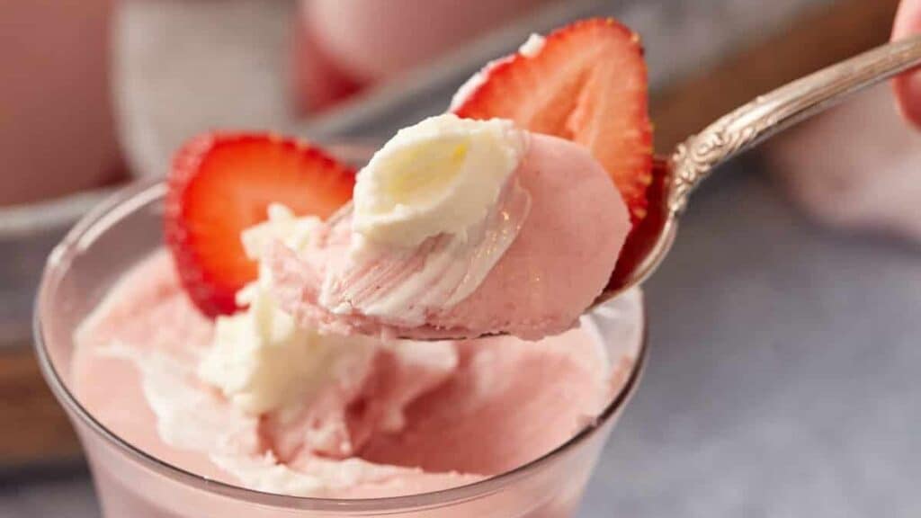A spoon full of strawberry mousse.