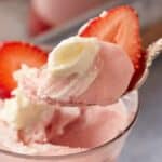 A spoon full of strawberry mousse.