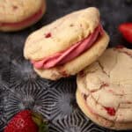 strawberry sandwich cookies on a dark background.