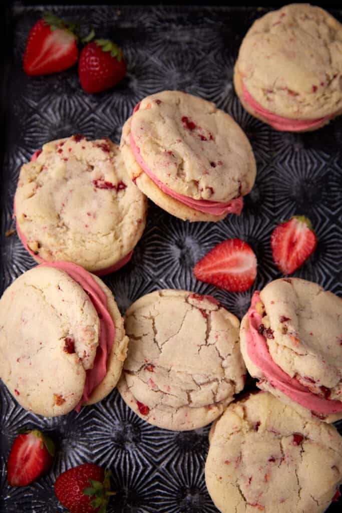 strawberry sandwich cookies on a dark background.