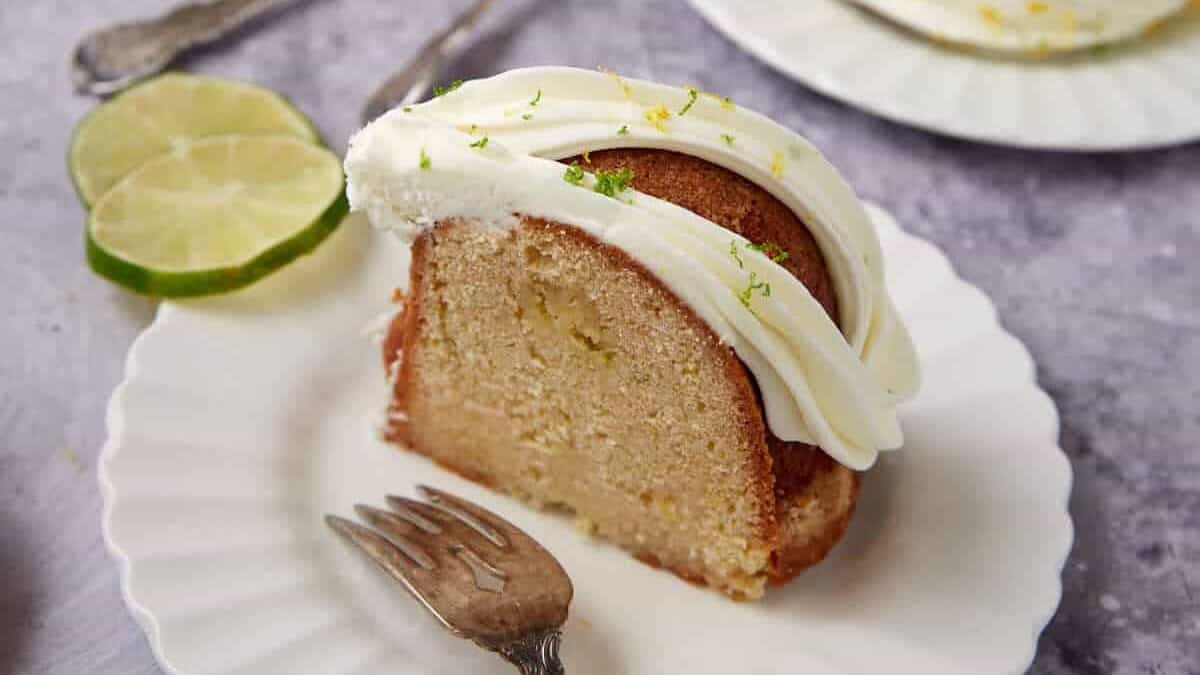 slice of 7 up cake on a white plate with a fork.