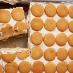 slices being cut out of the banana pudding poke cake.