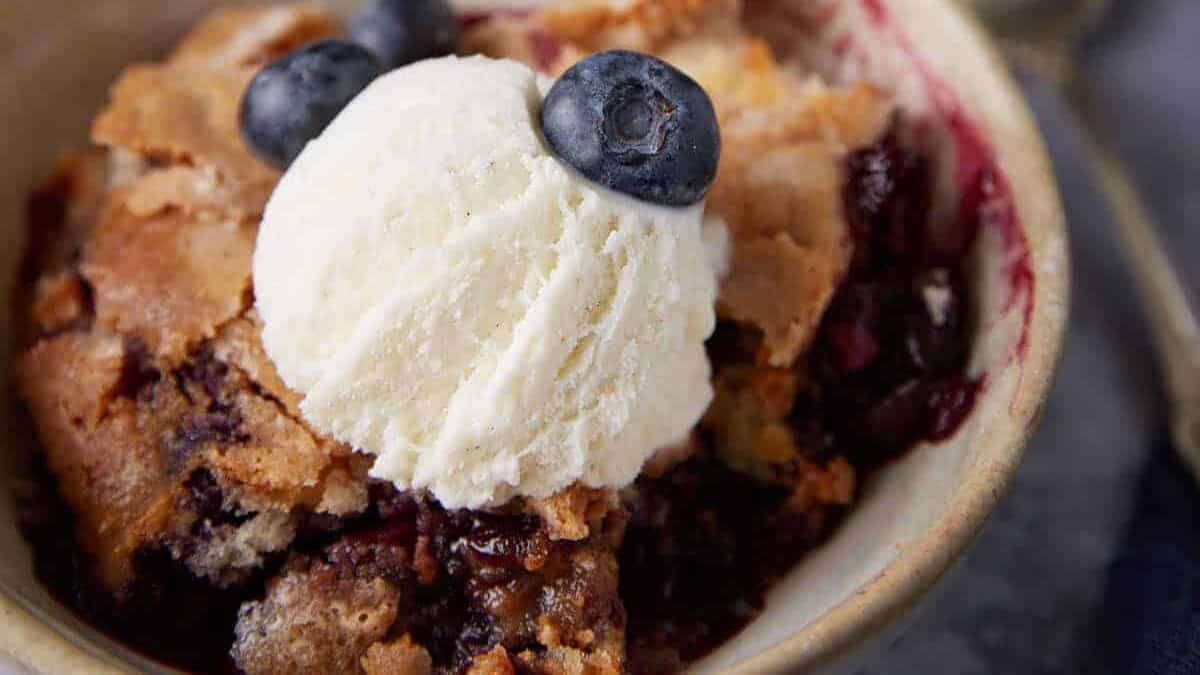 blueberry cobble with a scoop of cream on top.