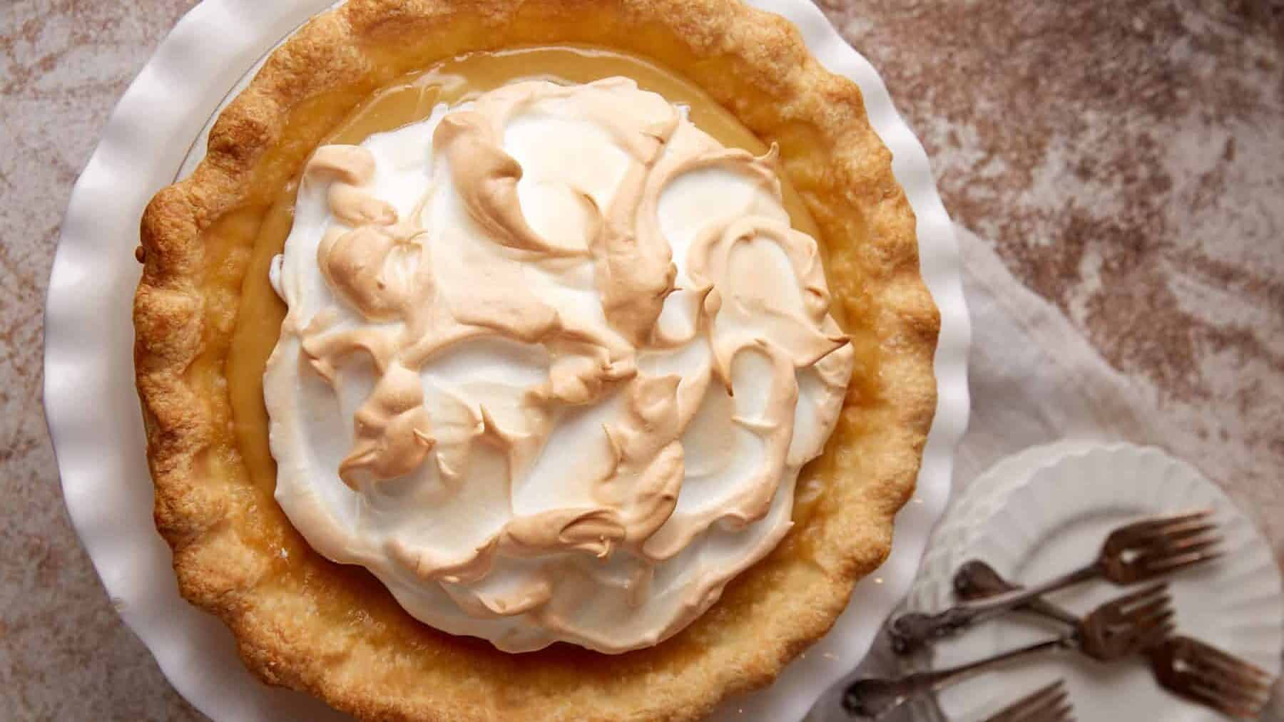 brown sugar pie with meringue on a white plate.