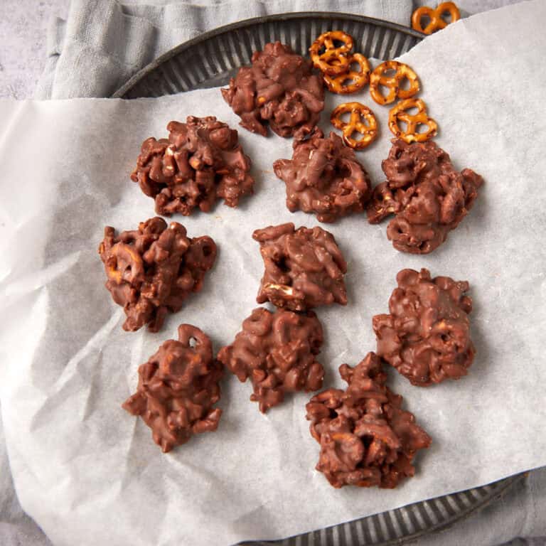 Chewy chocolate peanut clusters on a platter.