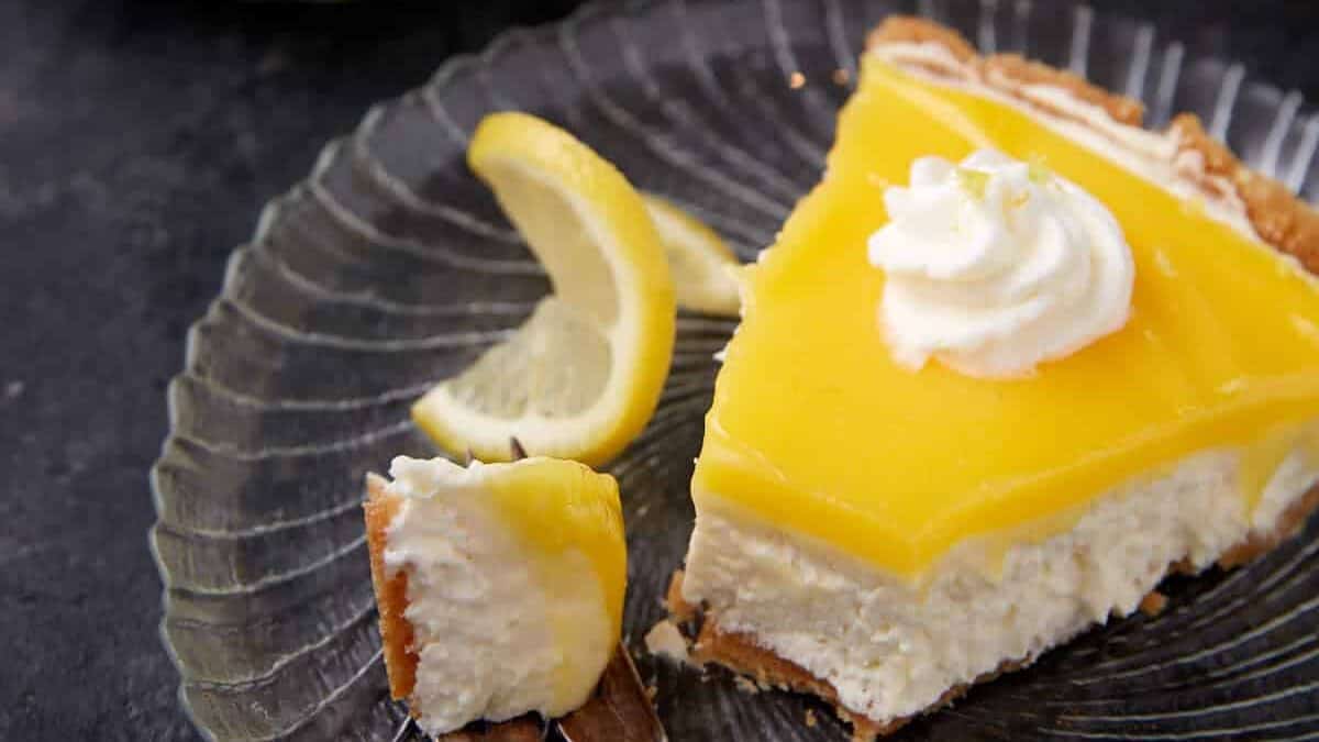 A bite taken out of a slice of lemon pie.