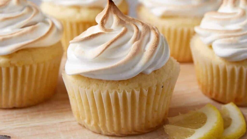A cake rack with lemon meringue cupcakes.