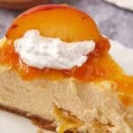 slice of peach cheesecake on a white plate.