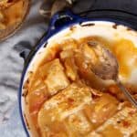 A half empty dish of peach cobbler.