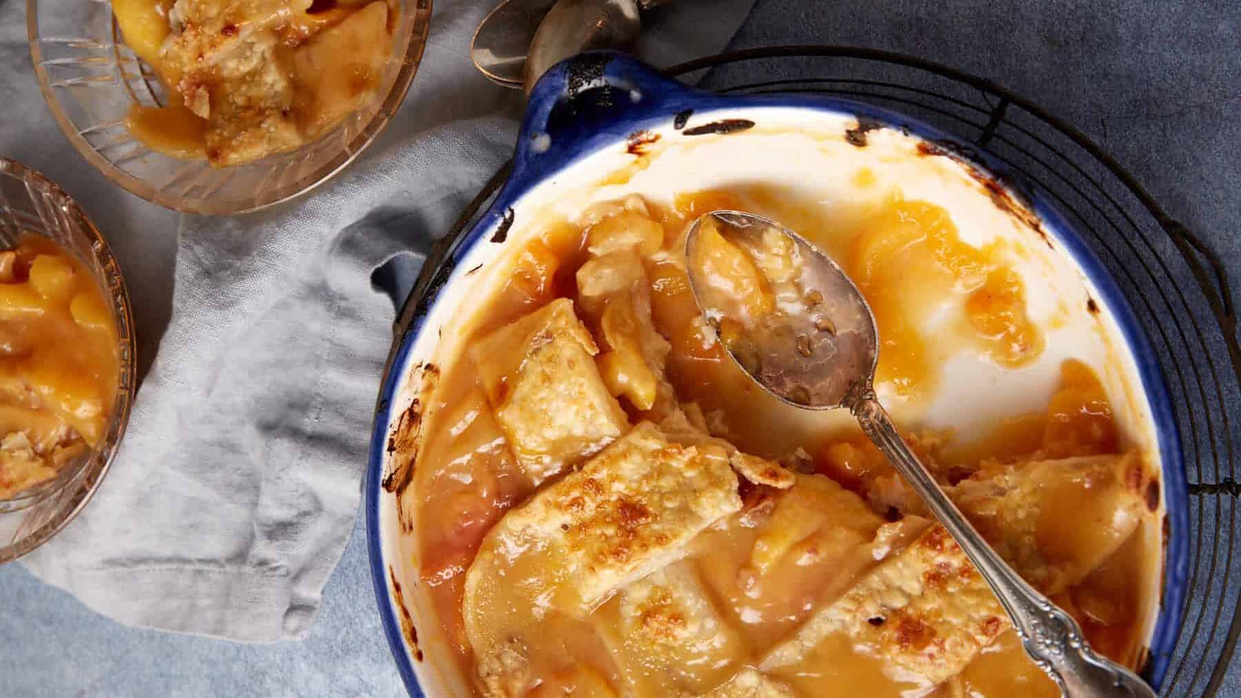 A half empty dish of peach cobbler.