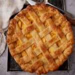 peach pie on a dark platter.