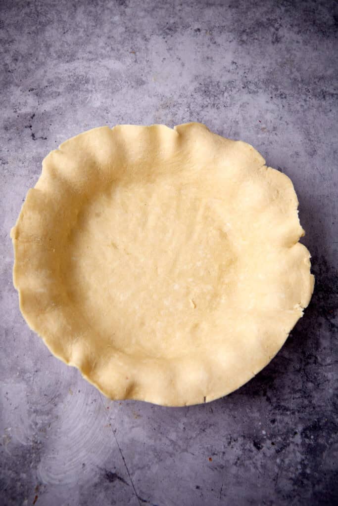 pie dough pressed into a pie dish.