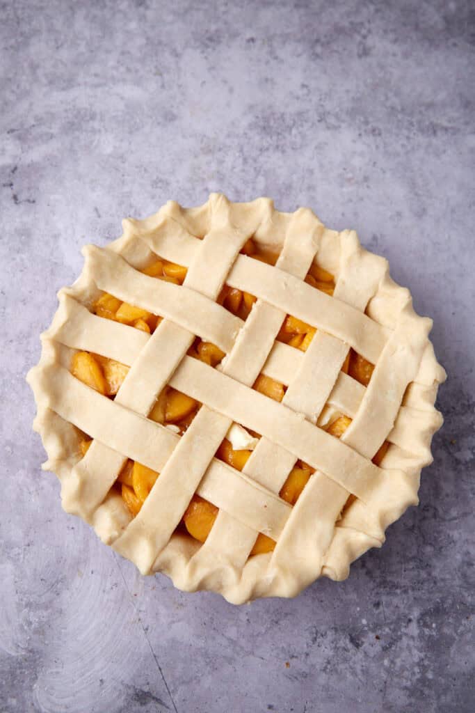 unbaked peach pie with a lattice crust.