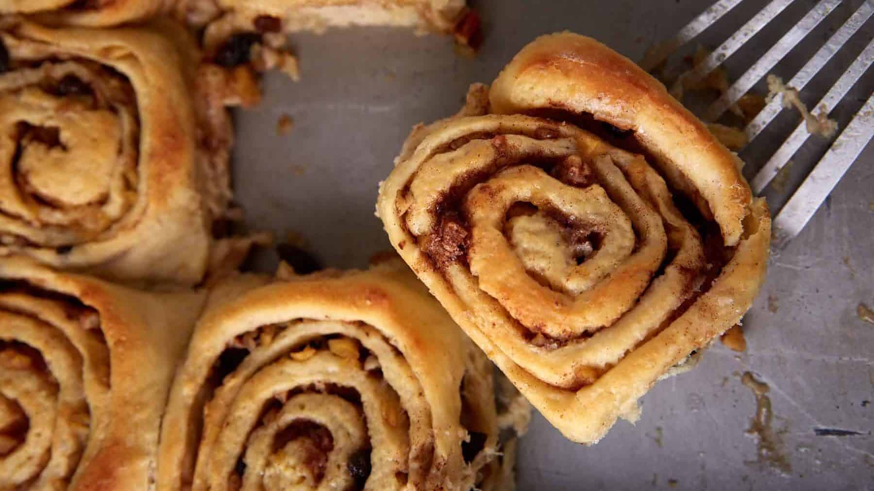 Baked apple cinnamon rolls in a pan.