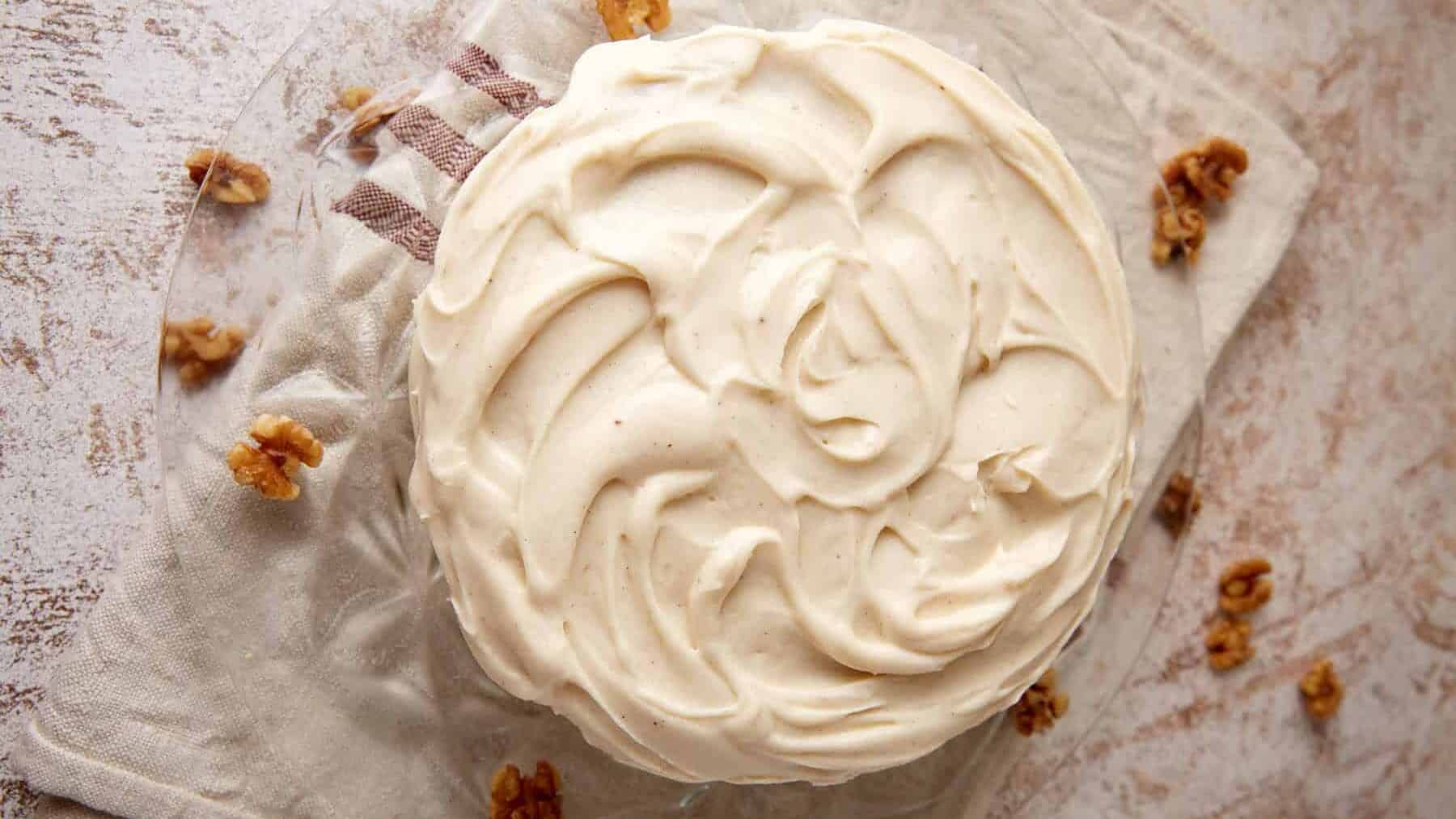 The top of a frosted cake with brown butter cream cheese frosting.
