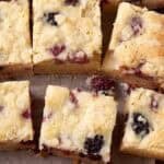 sliced fruit crumble bars on a baking sheet.