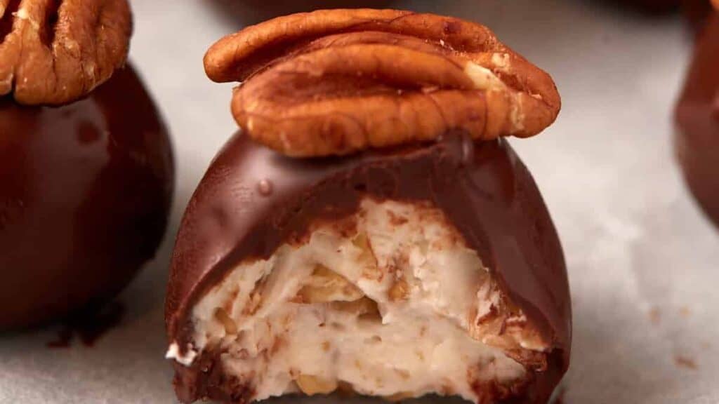 A bourbon ball with a bite taken out.