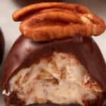 A bourbon ball with a bite taken out.