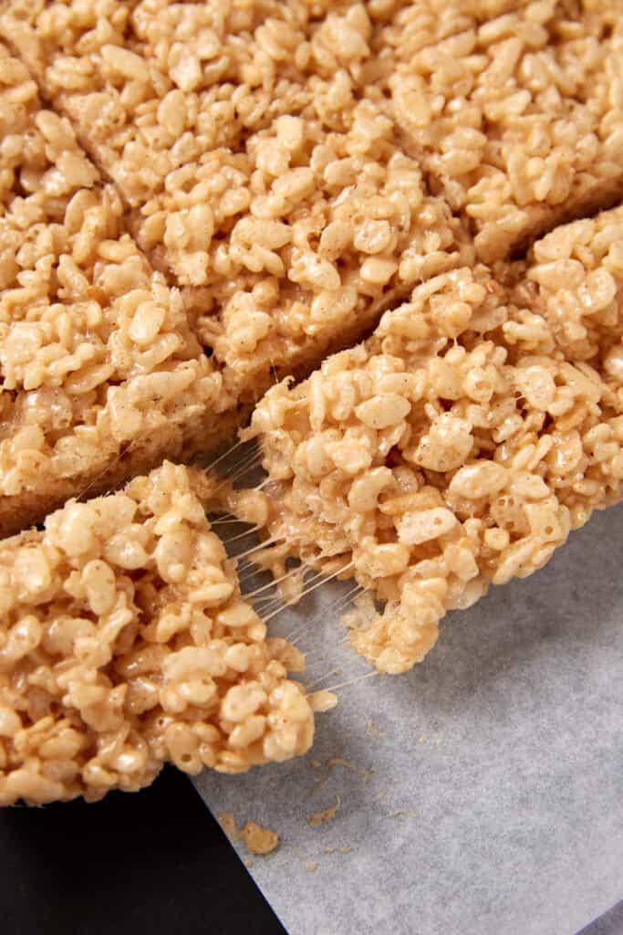 caramel Rice Krispie treats being pulled apart.