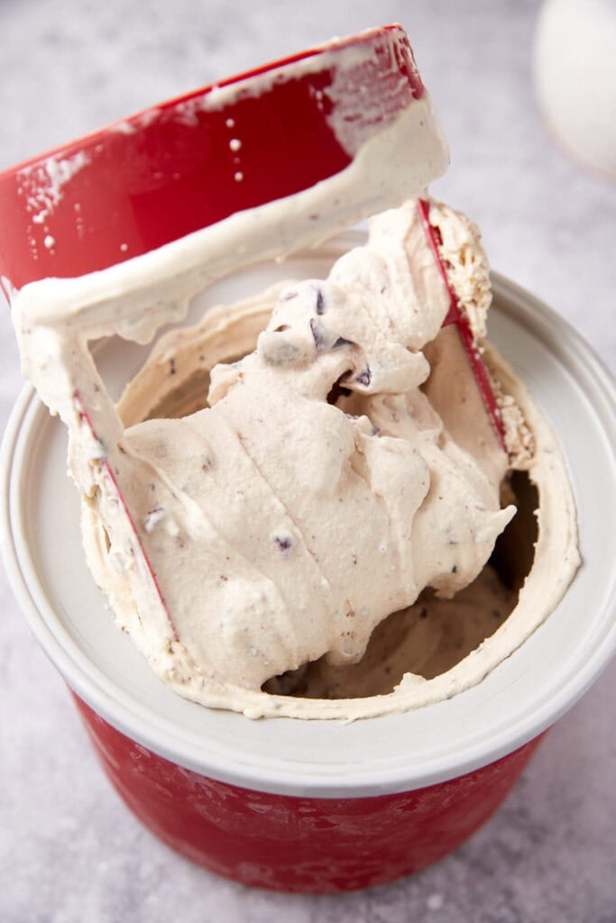 churned cherry chocolate ice cream in an ice cream maker.