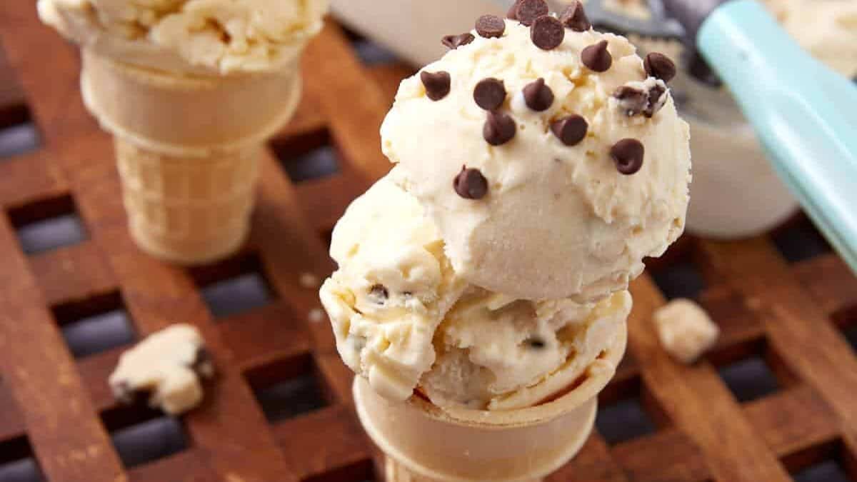 two cones with two scoops each of chocolate chip cookie dough ice cream.