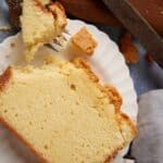 A slice of cream cheeses pound cake with a bite taken out.