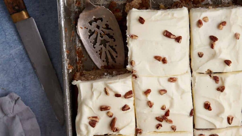 A hummingbird sheet cake cut into squares.