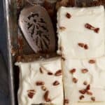 A hummingbird sheet cake cut into squares.