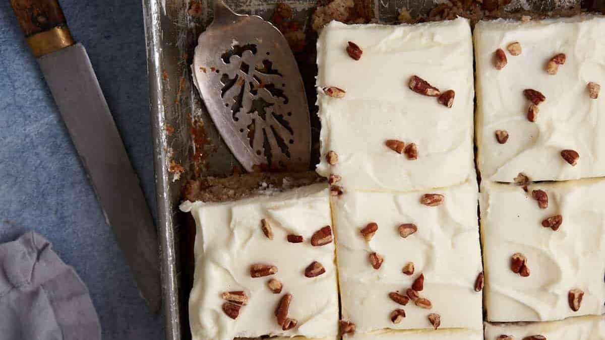 A hummingbird sheet cake cut into squares.