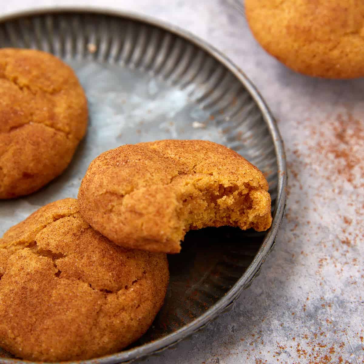 A pumpkin snickerdoodle with a bite taken out.