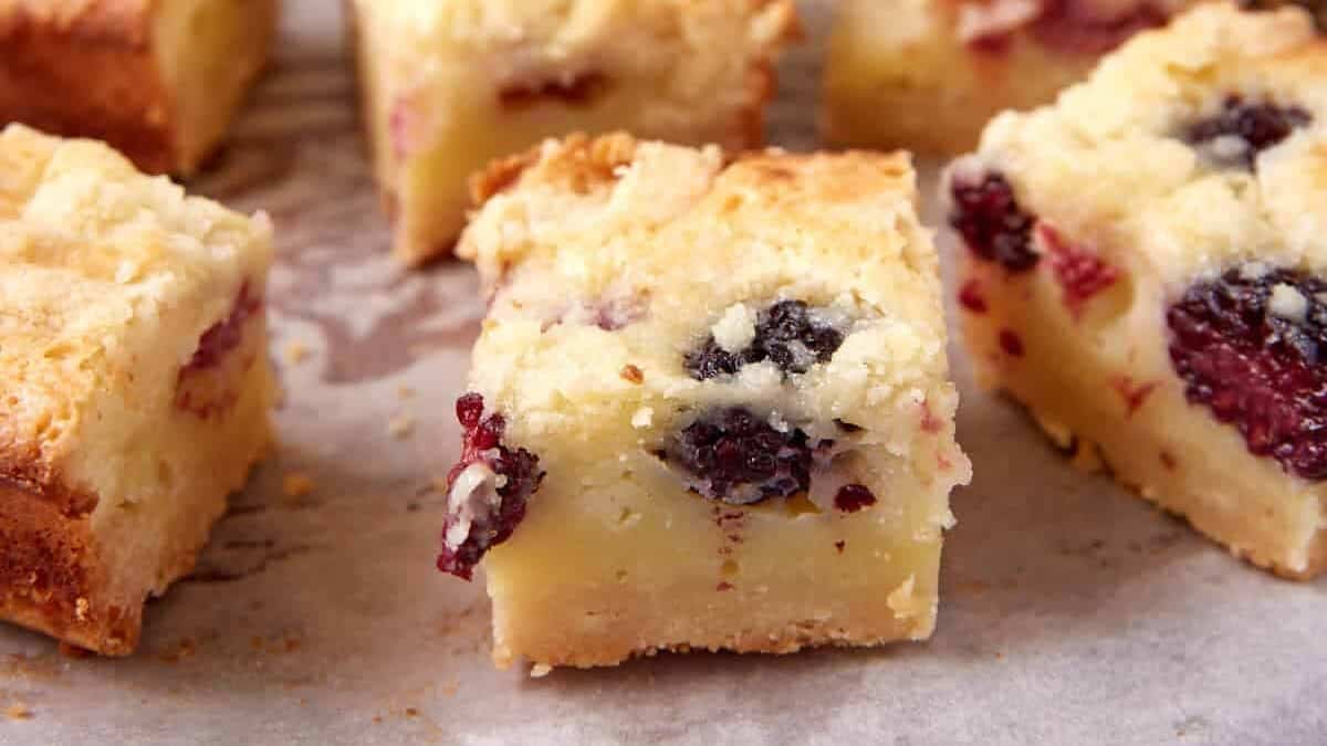 sliced fruit crumble bars on parchment paper.