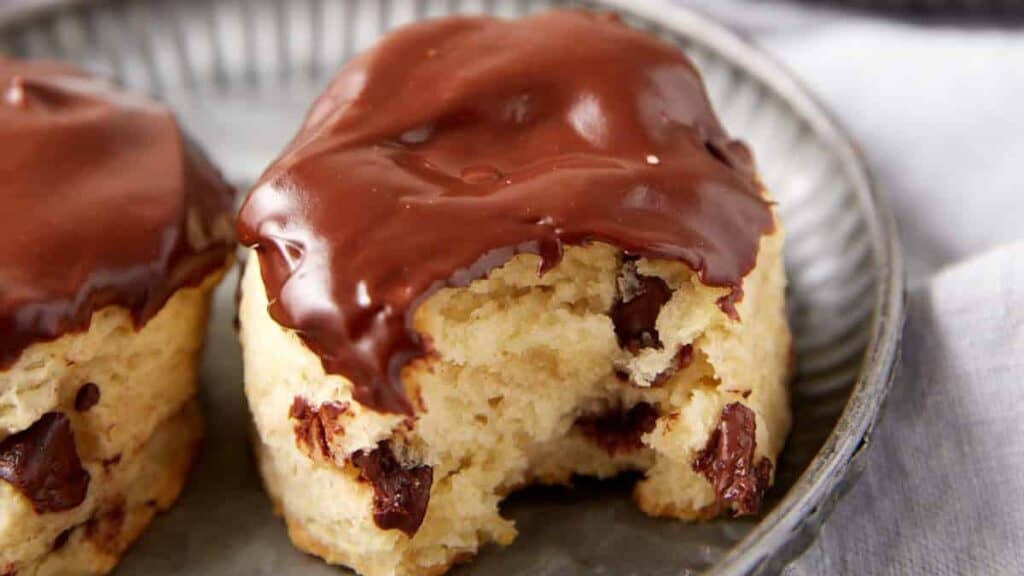 A chocolate dipped biscuit with a bite taken out.