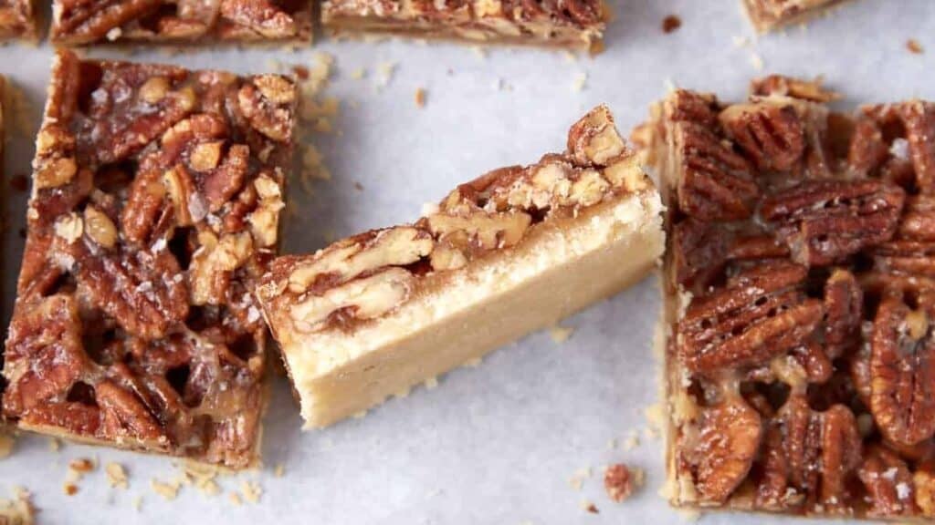 pecan pie bars on parchment paper.