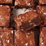 pecan brownies sliced on a parchment paper.
