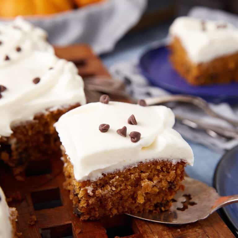 piece of pumpkin chocolate chip cake being picked up with a serving utensil.