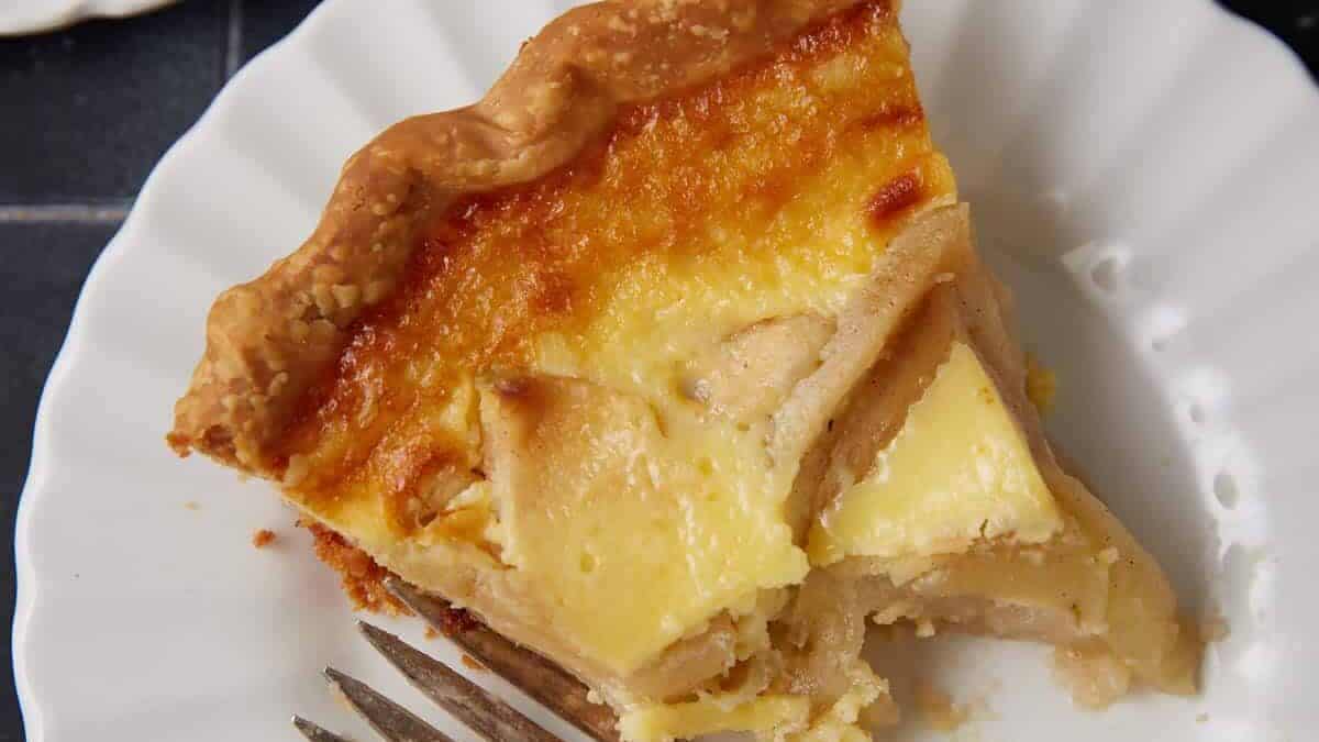 A half eaten slice of apple custard pie.
