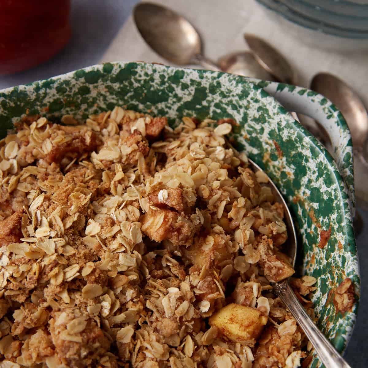 Close-up of the apple crisp after baking, showing bubbling apple filling and crisp golden oat topping.
