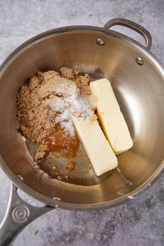 Butter, brown sugar, corn syrup, and salt in a saucepan ready to be melted together for caramel coating.