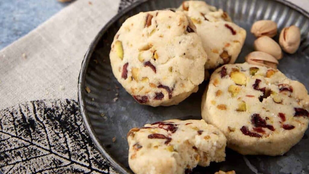 A small plate filled with cranberry shortbread cookies.