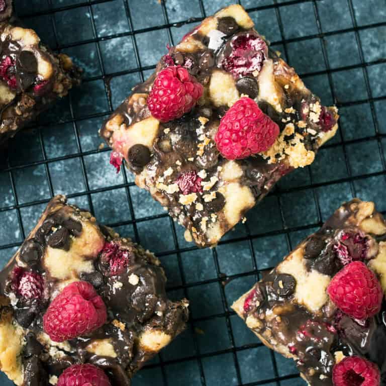 Chocolate raspberry bars cooling on a wire rack after baking.
