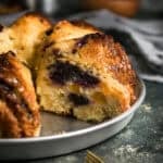 Close-up of the baked peach blueberry cake in the pan, highlighting the browned top and fruit-filled interior.