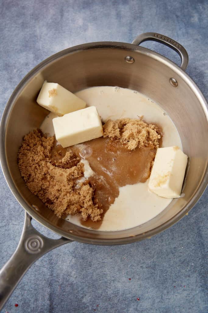 Butter, brown sugar, evaporated milk, and salt in a saucepan before cooking, ready to begin the fudge base.