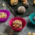 Chocolate truffles rolled and placed in colorful silicone candy cups with assorted coatings.
