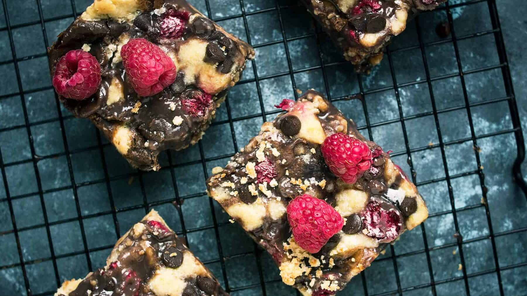 Chocolate raspberry bars cooling on a wire rack after baking.