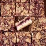 Close-up view of cherry streusel bars cut into squares with one bar turned on its side.