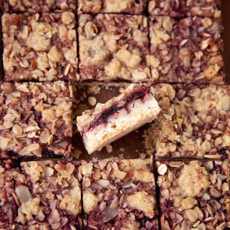 Close-up view of cherry streusel bars cut into squares with one bar turned on its side.