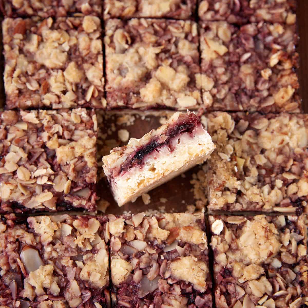 Close-up view of cherry streusel bars cut into squares with one bar turned on its side.