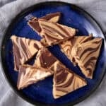 Tiger Butter triangles served on a dark blue plate.